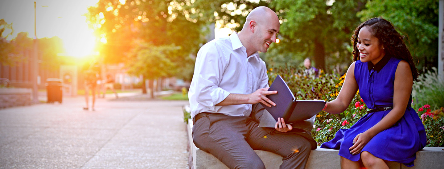 students discussing work on campus featured