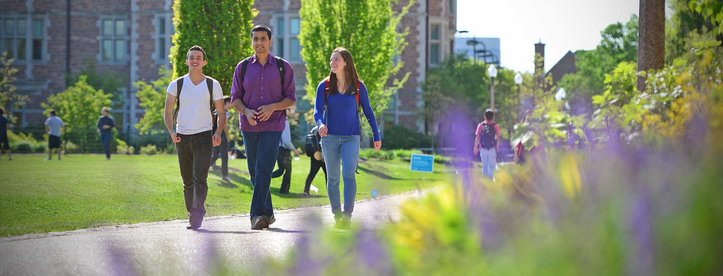 group of students walking on campus featured