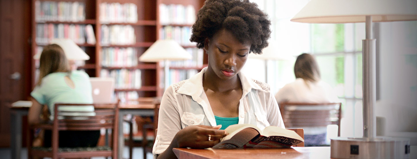 student reading in library featured