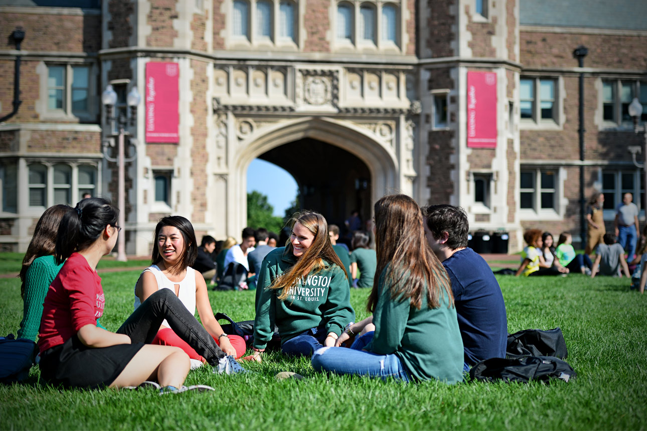 group of students sitting and talking on campus in-line